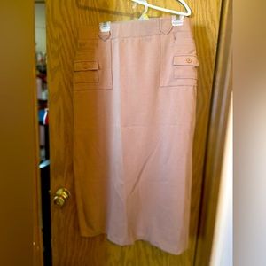 Long tan skirt with multiple pockets.